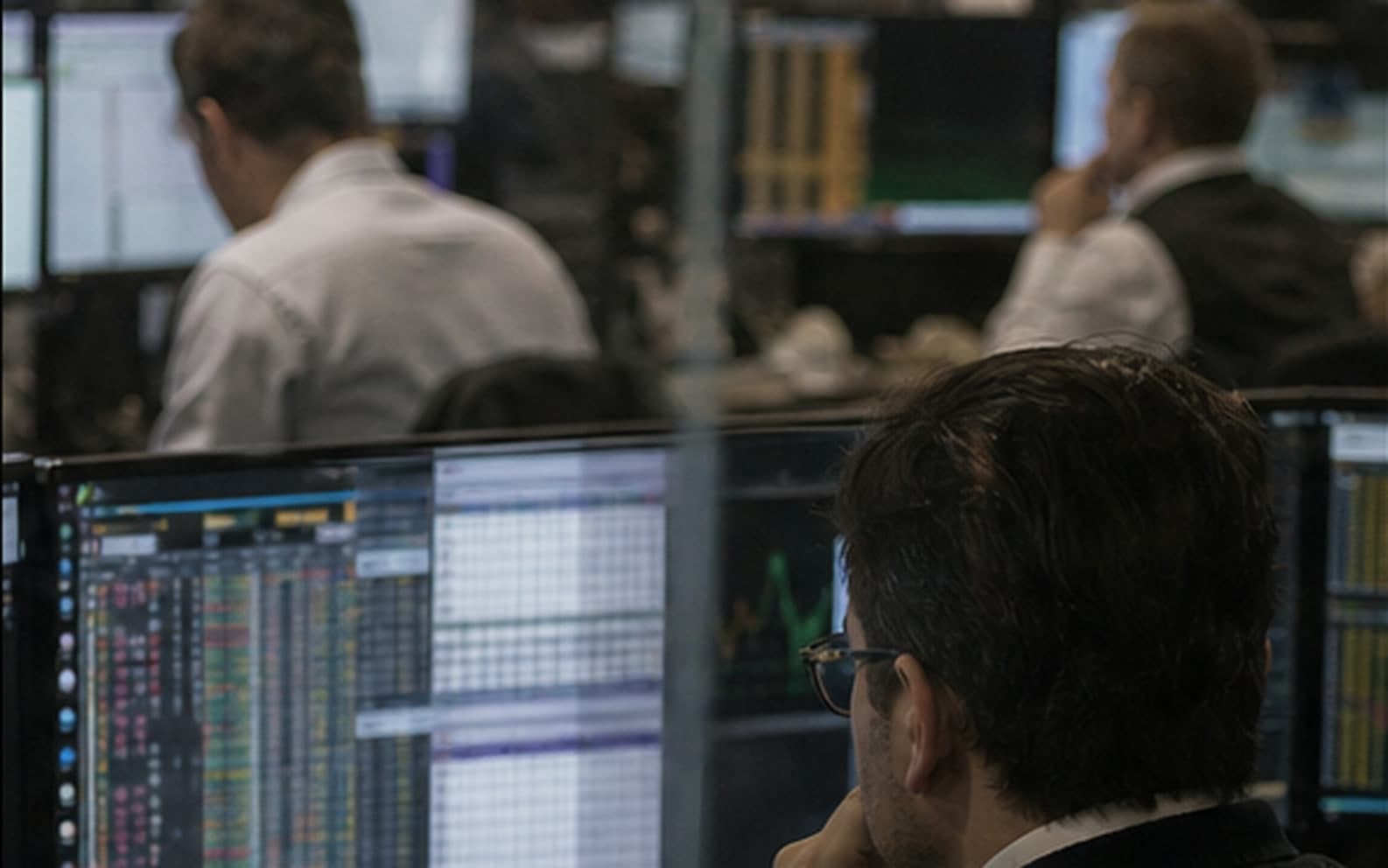 An analyst monitoring markets from an institutional trading desk