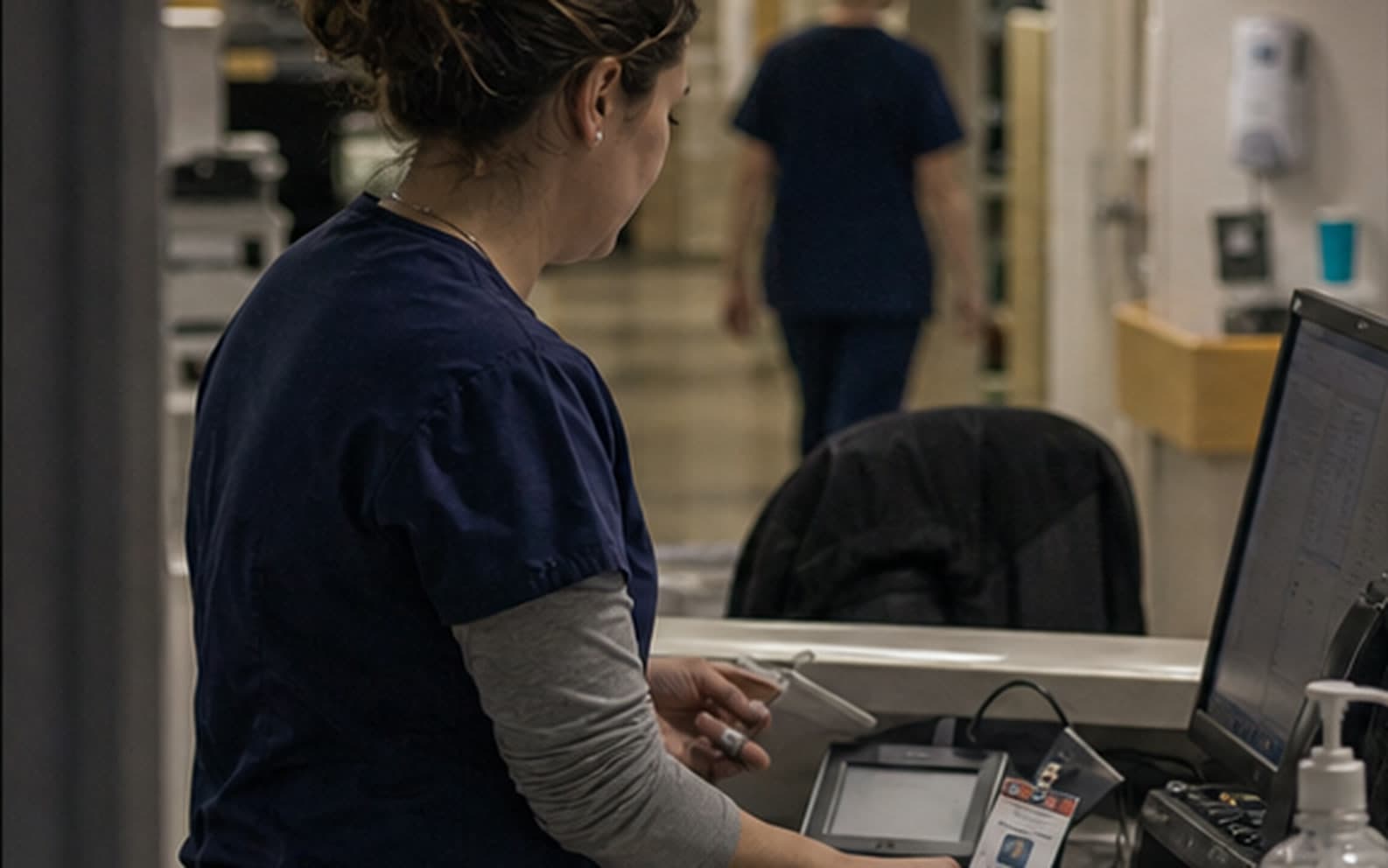 A nurse signing in at a hospital workstation